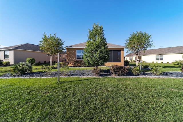 single story home featuring a front yard and a sunroom