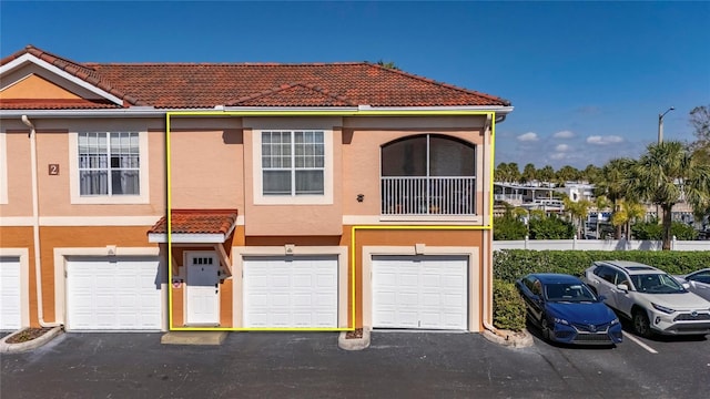 multi unit property featuring a garage