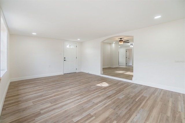 spare room featuring ceiling fan and light hardwood / wood-style floors