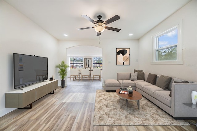 living room with ceiling fan and light hardwood / wood-style floors