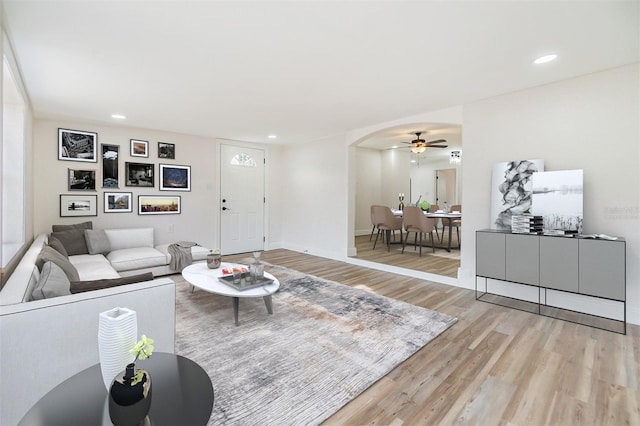 living room featuring ceiling fan and wood-type flooring