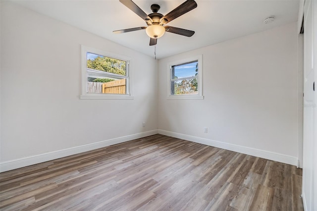 empty room with ceiling fan and light hardwood / wood-style floors