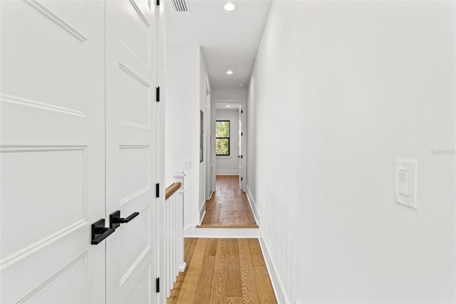 corridor with light wood-type flooring