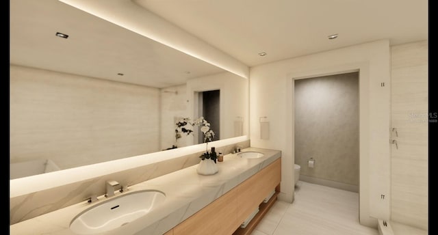 bathroom with toilet, vanity, and tile patterned flooring