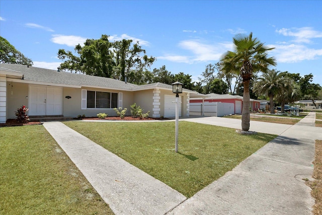 ranch-style house with a garage and a front yard