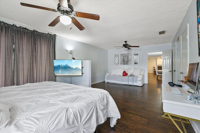 bedroom featuring vaulted ceiling, dark hardwood / wood-style floors, ceiling fan, and a textured ceiling