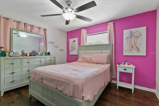 bedroom with ceiling fan, a textured ceiling, and dark hardwood / wood-style flooring