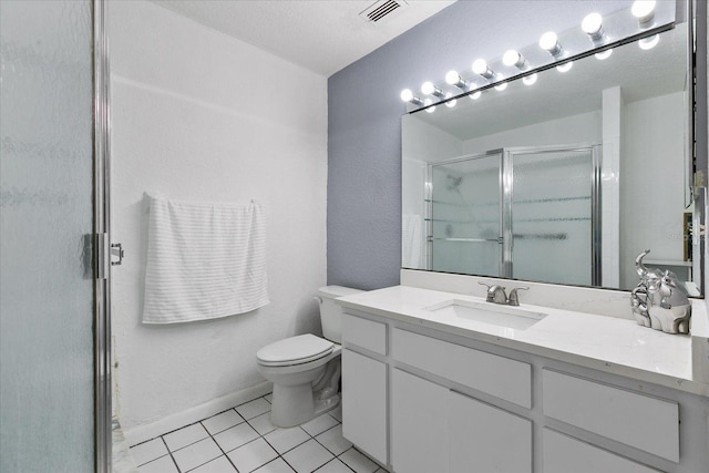 bathroom with tile patterned flooring, vanity, an enclosed shower, and toilet