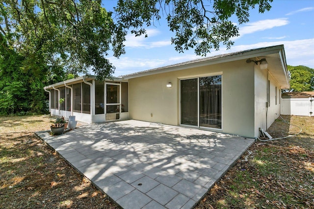 rear view of property featuring a patio area and a sunroom