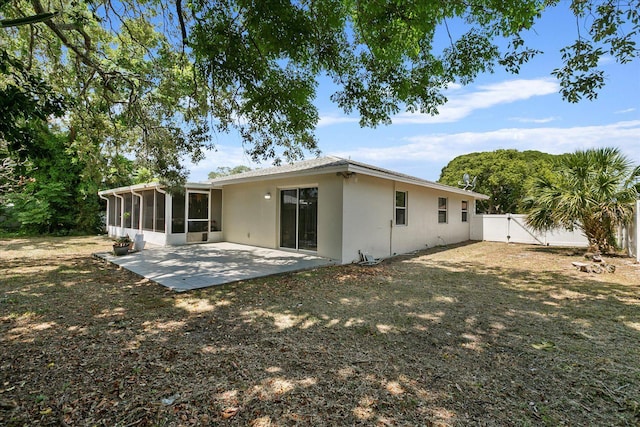 rear view of property with a patio and a sunroom