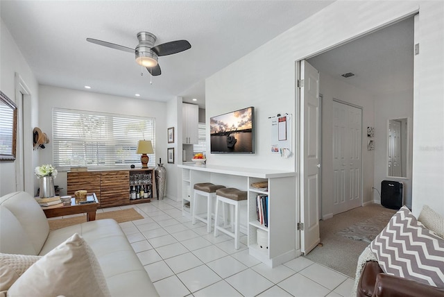 tiled living room featuring ceiling fan