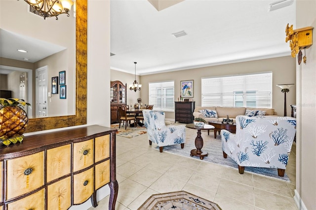 living room with an inviting chandelier and light tile patterned flooring