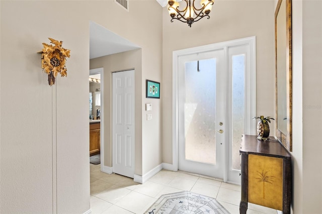 entrance foyer featuring light tile patterned flooring and a notable chandelier