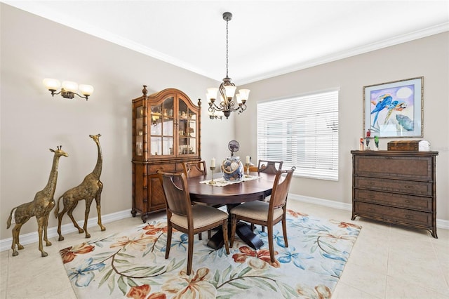 tiled dining space featuring ornamental molding and a chandelier