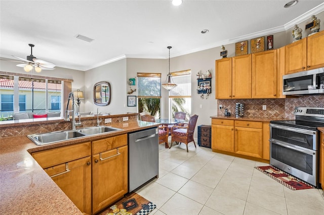 kitchen featuring appliances with stainless steel finishes, tasteful backsplash, sink, hanging light fixtures, and crown molding