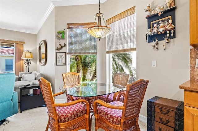 dining room with light tile patterned flooring and ornamental molding