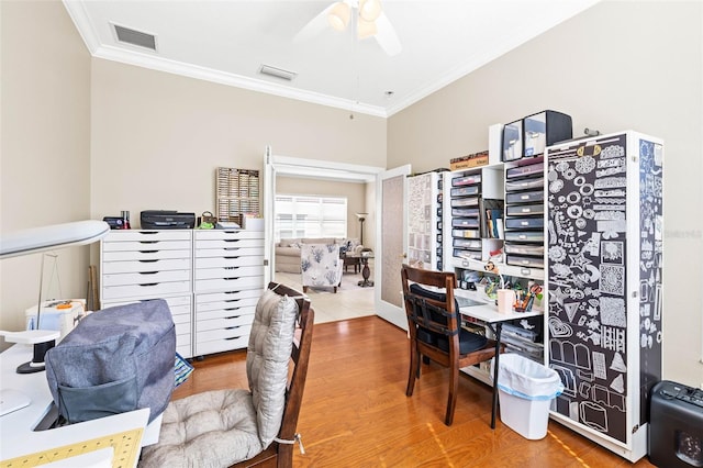 office space featuring crown molding, wood-type flooring, and ceiling fan