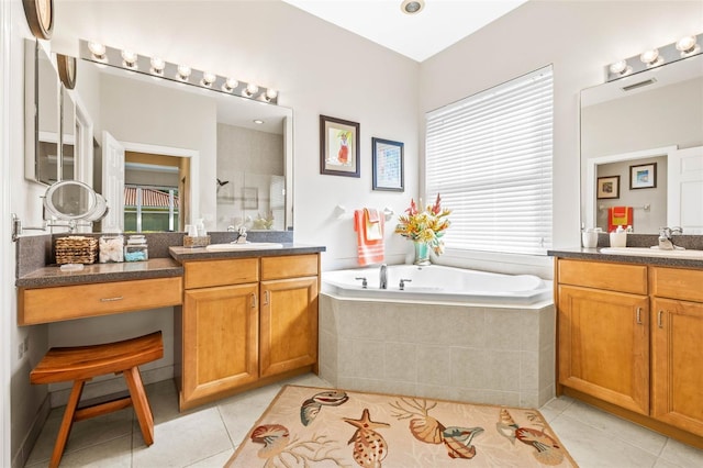 bathroom with vanity, tile patterned floors, and plus walk in shower