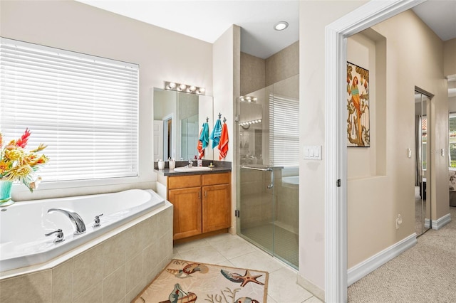 bathroom with vanity, tile patterned flooring, a wealth of natural light, and plus walk in shower