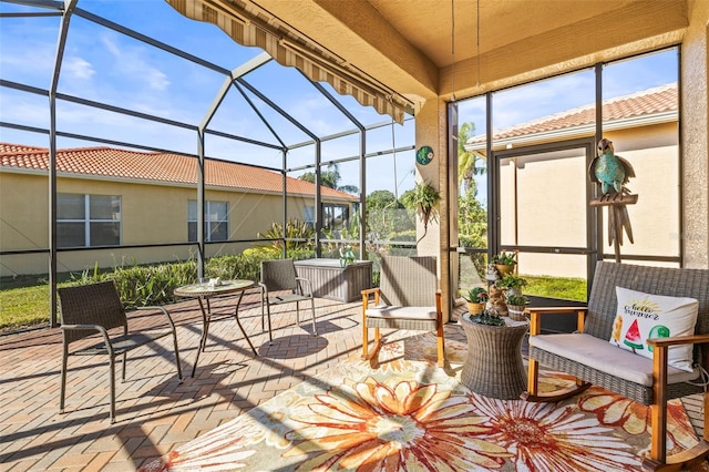 view of patio featuring glass enclosure