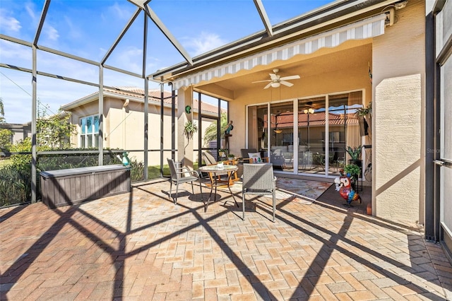 unfurnished sunroom with ceiling fan