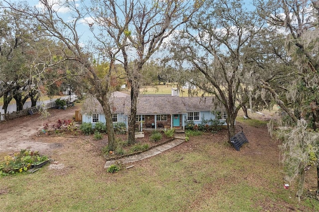 single story home featuring a front lawn