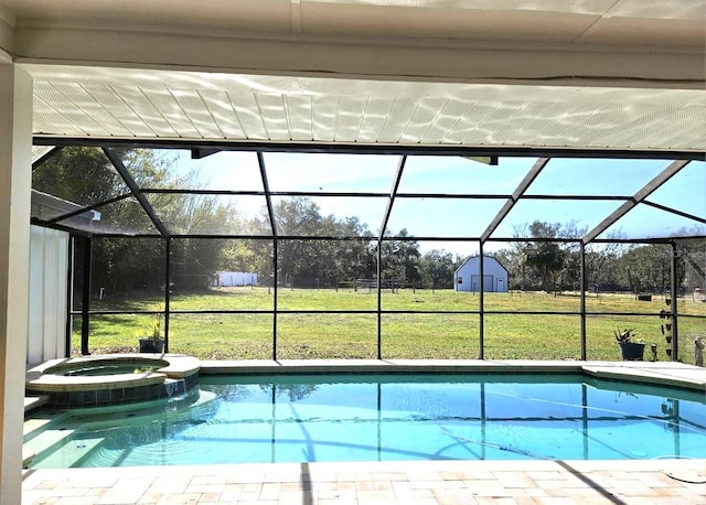 view of pool featuring an in ground hot tub, glass enclosure, and a lawn