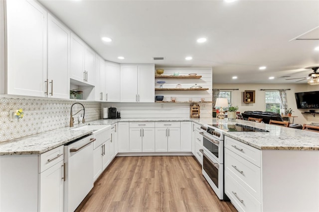 kitchen featuring white appliances, a sink, a peninsula, open shelves, and white cabinets