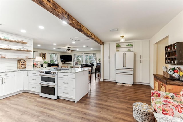 kitchen with white appliances, visible vents, a peninsula, open shelves, and white cabinets