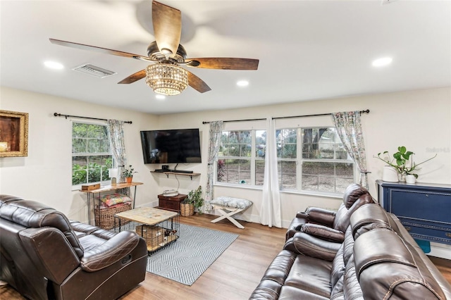 living room featuring a ceiling fan, visible vents, recessed lighting, and wood finished floors