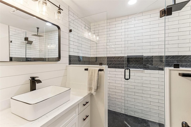 full bathroom featuring a stall shower, vanity, and recessed lighting
