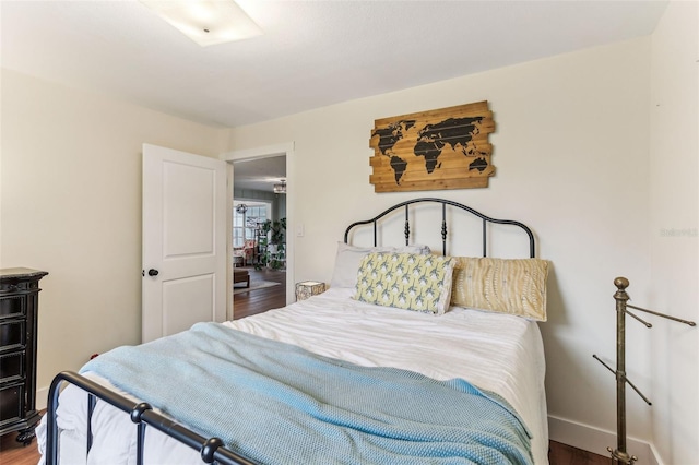 bedroom with wood finished floors and baseboards