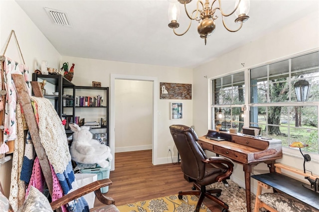 office area with wood finished floors, a healthy amount of sunlight, visible vents, an inviting chandelier, and baseboards