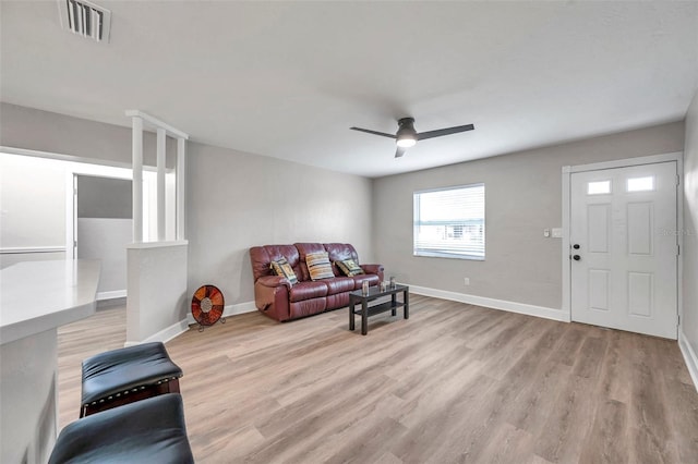 living room featuring ceiling fan and light hardwood / wood-style flooring