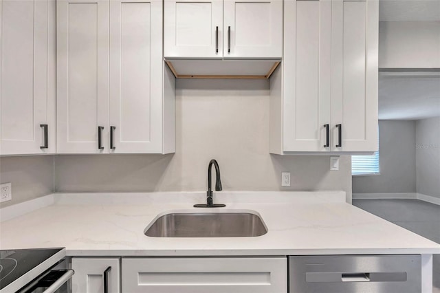 kitchen featuring light stone counters, sink, white cabinets, and dishwasher