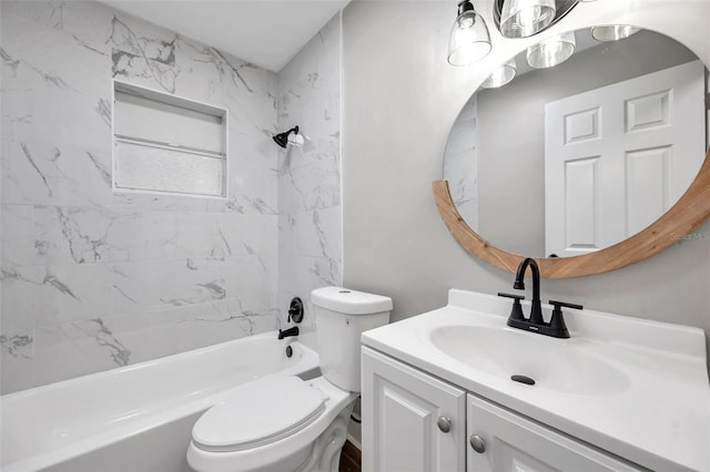 full bathroom featuring toilet, tiled shower / bath, and vanity