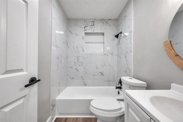 full bathroom with toilet, vanity, wood-type flooring, and tiled shower / bath