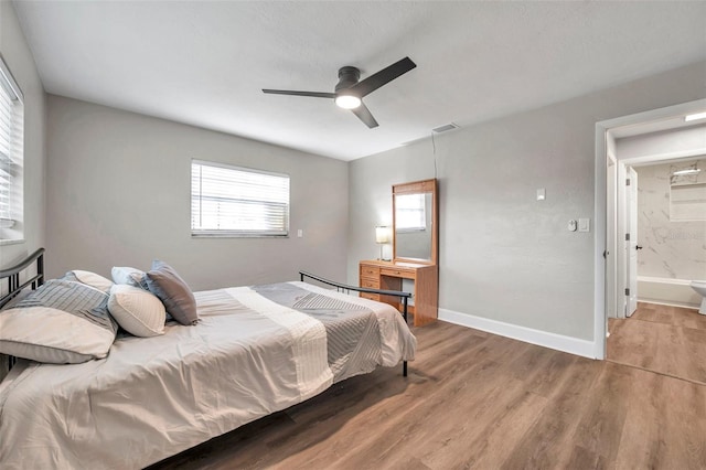 bedroom with ceiling fan, wood-type flooring, and ensuite bathroom