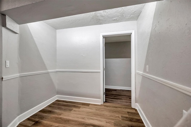 walk in closet with dark hardwood / wood-style floors