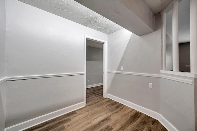 interior space with a textured ceiling and hardwood / wood-style flooring