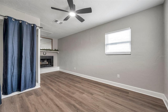 unfurnished living room featuring hardwood / wood-style flooring and ceiling fan