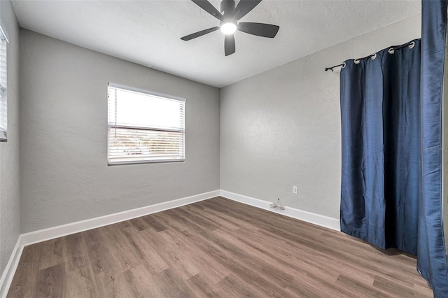 unfurnished room with ceiling fan and hardwood / wood-style floors