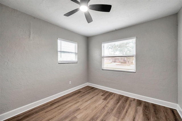 unfurnished room with hardwood / wood-style flooring and ceiling fan