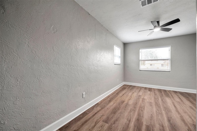 spare room featuring ceiling fan and hardwood / wood-style flooring