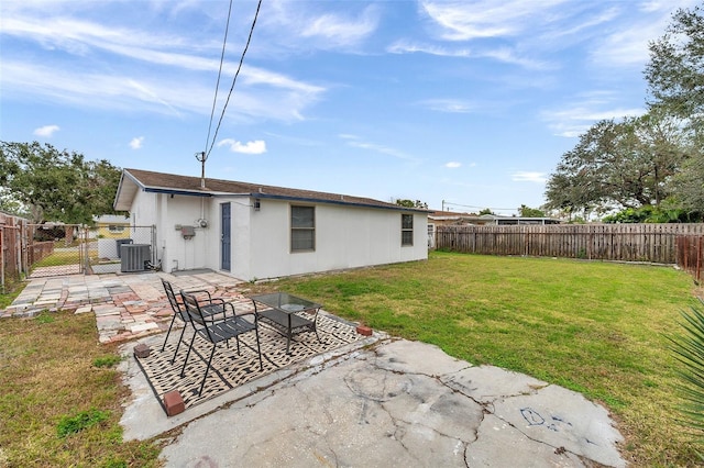 back of house with a lawn, cooling unit, and a patio area