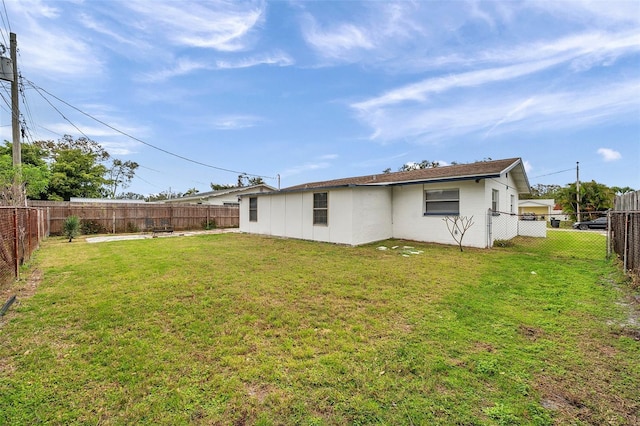 back of property featuring a lawn