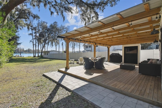 wooden terrace with grilling area, a lawn, and a water view