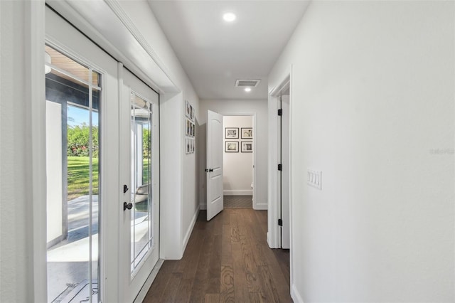 corridor with dark wood-type flooring and french doors