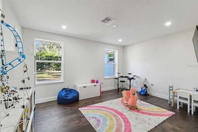 recreation room with dark hardwood / wood-style floors