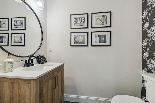 bathroom featuring vanity and toilet